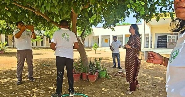 Srishtimitra team members placing bird feeders